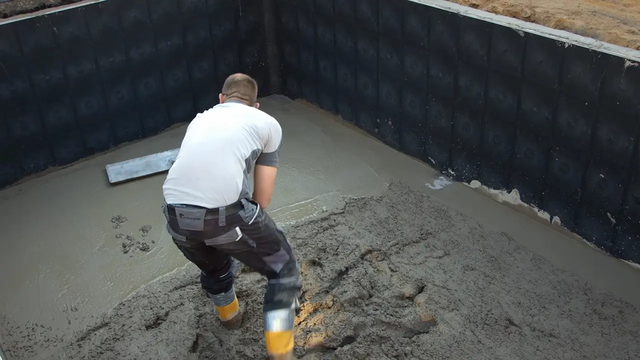 Beton am Boden des Pools glattstreichen