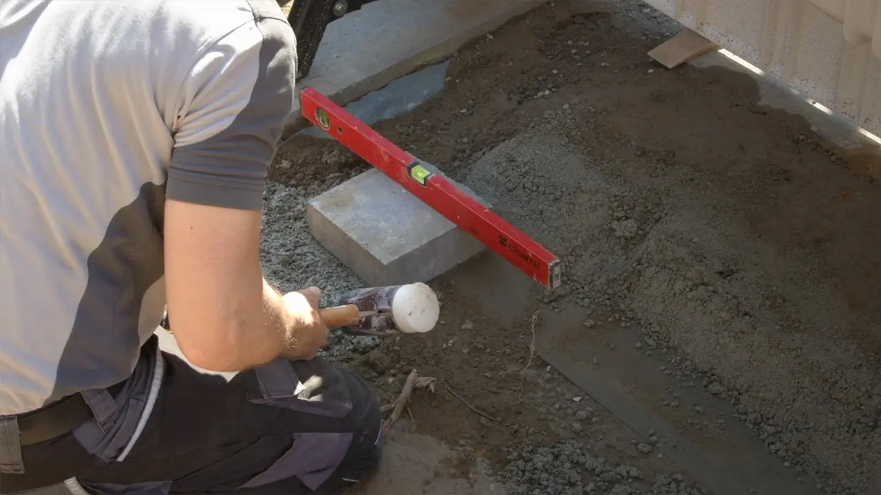 Steine Pooltreppe mit Wasserwaage ausrichten